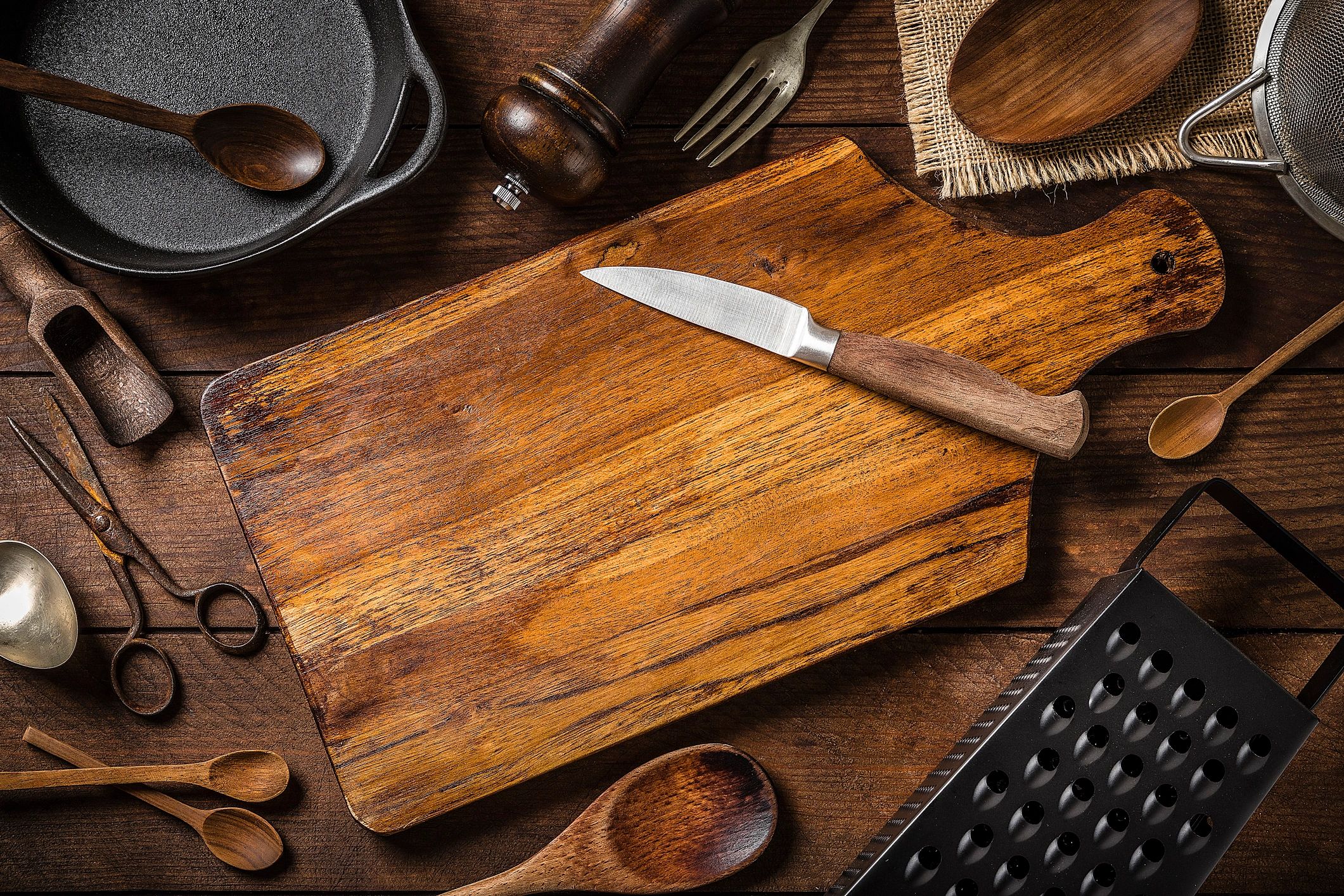 Flat lay of cutting board and kitchen utensils with copy space