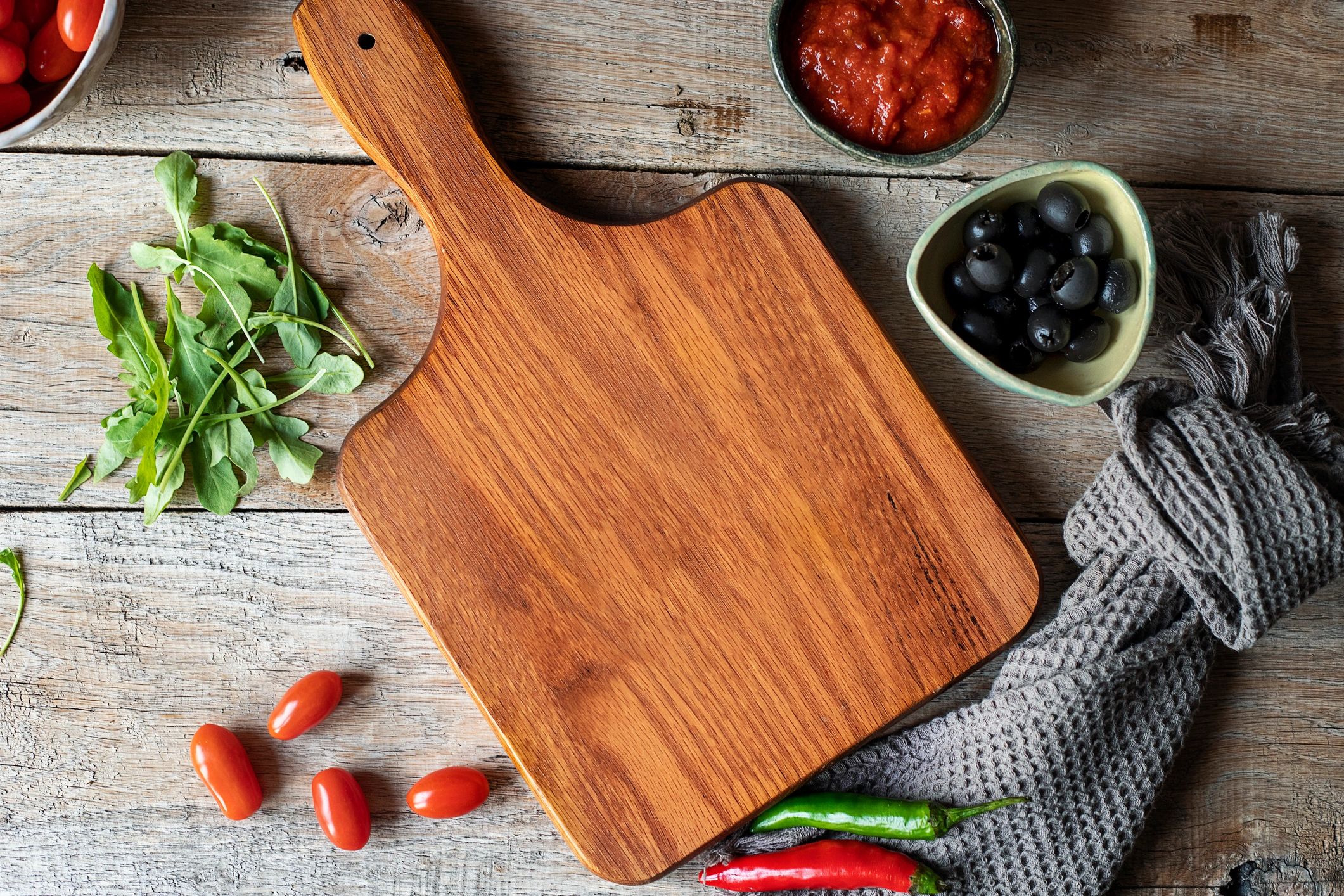 Cutting board with fresh vegetables on a rustic table